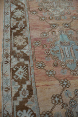 Distressed vintage Oushak runner's coffee brown geometric border and dusty rose abrashed field.