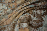 Distressed pile of vintage Oushak rug in folds with coffee brown, slate blue, dusty rose hues.