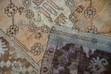 Distressed vintage Oushak runner showing faded dusty rose, gold patterns and woven reverse.