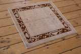 Distressed vintage Oushak rug corner, even wear, deep chocolate arabesque border.