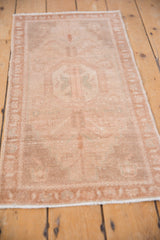 Distressed Oushak rug close-up showing even wear, subtle tree of life finials, and soft beige tones.