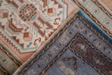 Blush and seafoam floral pile of distressed Oushak rug, with hand knotted back.