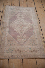 Faded stepped medallion and soft texture of this distressed vintage Oushak rug.