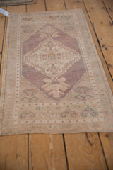 Hand knotted distressed Oushak rug runner, featuring an abrashed diamond medallion in soft lavender.