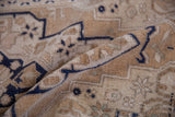 Distressed vintage Oushak rug's deep beige pile with even wear and cobalt blue geometric pattern.