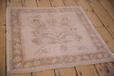 Vintage distressed Oushak rug corner, showing pale coffee brown tiered leaf border.