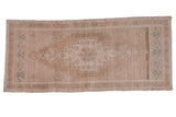 Distressed vintage Oushak runner, faded beige stepped medallion with seafoam accents.