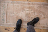 Distressed Oushak runner pile with stepped geometric motifs and subtle abrashes in beige and seafoam.
