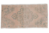 Distressed vintage Oushak rug runner, scalloped medallion, soft peach and faded green hues, 1'9