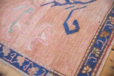 Textured pile of distressed Oushak rug with abrashed beige field and patterned cobalt blue border.