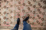 Distressed Oushak runner with abrashed dusty blush, bronze, and seafoam floral bouquets.