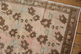 Distressed Oushak rug shows bronze floral bouquets on blush abrashed ground, faint foundation.