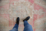 Low-pile, hand-knotted texture of a distressed Oushak runner in soft pink and seafoam.