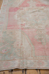 Detail of even wear to knot heads on the distressed Oushak rug's low pile.