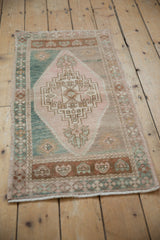 Distressed Oushak runner with faded rose, teal, geometric floral, and lightning spandrel patterns.