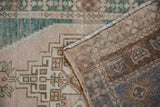 Hand-knotted brown foundation and beige, deep ocean green geometric pile of a vintage Oushak.