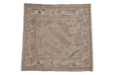 Distressed Vintage Oushak square rug with nuanced floral and serrated leaf motifs, in beige, ivory, and forest green.