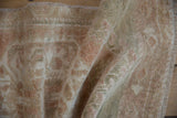 Oushak rug pile with even wear, featuring distressed beige, seafoam, and pale copper.