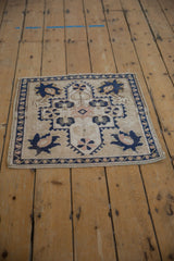 Distressed pile texture on a vintage Oushak rug with secure side selvage and vine border.