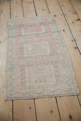 Abrashes and even pile wear across distressed blush and beige geometric Oushak.