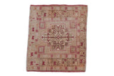 Distressed vintage Oushak rug featuring a pale raspberry red shield medallion on an ivory field.