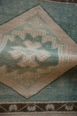 Vintage Distressed Oushak rug pile with seafoam green geometric motifs and worn texture.