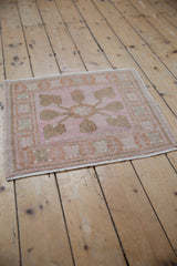 Distressed vintage Oushak square rug, pink, copper, ivory, seafoam tones, soft floral pattern.