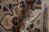 Distressed beige Oushak rug pile showing navy blue and pale coffee floral motifs with even wear.