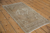 Distressed beige and ivory Oushak border with intact side selvage.