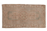 Distressed vintage Oushak rug mat with triple medallion, geometric border in beige and seafoam green.