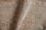 Vintage Distressed Oushak rug showing soft ivory and seafoam green pile texture.