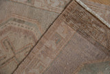 Hand-knotted foundation of a vintage distressed Oushak rug with muted pile and fringe.
