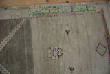 Vintage Distressed Oushak rug with silver abrash, pink, green border motifs, and germinating plant details.