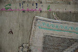 Distressed vintage Oushak rug's side, showing its intact selvage and woven foundation.