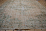 Distressed pile of vintage Oushak carpet with faded ivory and seafoam green.