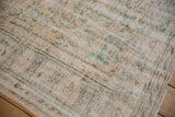Distressed vintage Oushak rug pile with mostly even wear, ivory, seafoam green, and coffee brown.