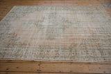 Distressed ivory and seafoam green border on a vintage Oushak rug with intact selvage.