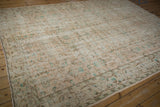 Worn ivory pile and pale turquoise floral vinery on a vintage distressed Oushak rug corner.