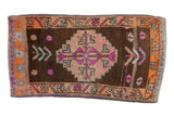 Distressed Kars rug, coffee brown, stepped medallion, colorful floral designs, 1.5x3 feet.