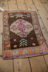 Tangerine orange border with fuchsia and aqua blue geometric motifs on vintage Kars rug.