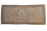 Distressed Oushak runner rug, pale pink field, central medallion, bronze meandering vine border, 1'8