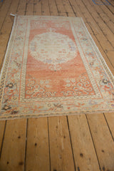Distressed vintage Oushak rug showing faint foundation through even pile wear.
