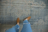 Distressed Oushak carpet texture, faded denim blue and apricot floral patterns.
