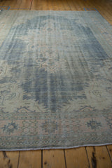 Vintage distressed Oushak carpet, rich texture with denim blue, ivory, and pale apricot tones.