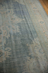 Textured distressed Oushak rug featuring faded denim blue and pale apricot hues.