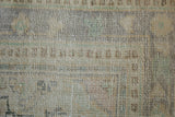Distressed Oushak rug texture showing wear to knot heads and time-softened tones.