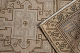 Distressed vintage Oushak rug pile with geometric brown patterns, even wear, and folded border.