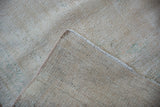 Distressed ivory Oushak carpet pile and hand-knotted foundation texture.