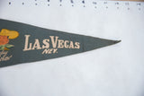 Pointed end of vintage dark green felt Las Vegas pennant, textured, with minor pinhole.
