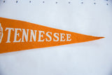 Mid-century vintage orange felt pennant showing white 'TENNESSEE' lettering and tapered end.